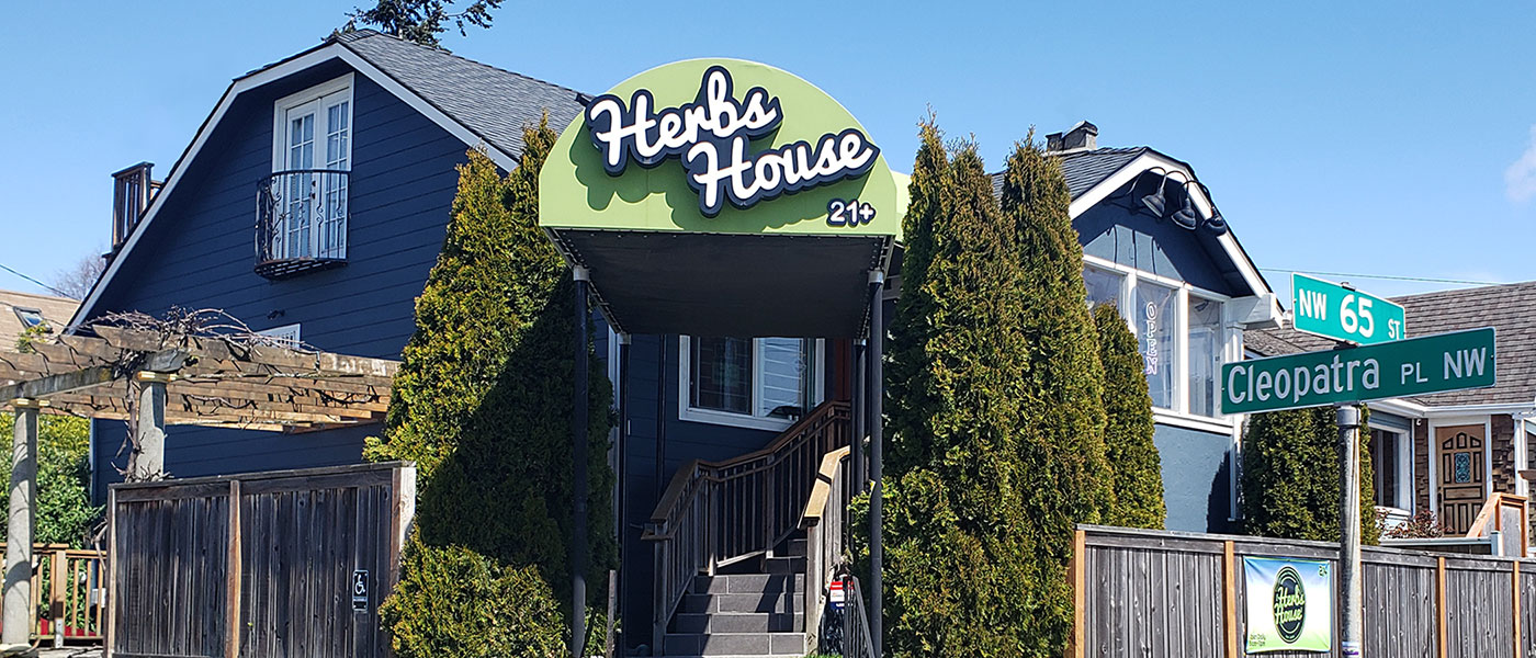 Exterior of Herbs House Weed Dispensary on a sunny blue sky day